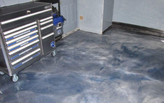 This image shows a garage with a metallic epoxy floor.