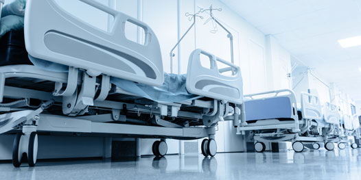 This image shows a hospital floor with beds.