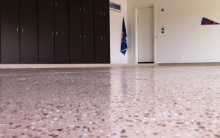 This image shows a garage floor with flake epoxy painted floor.