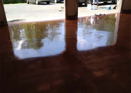 This image shows a garage floor with metallic epoxy painted floor.