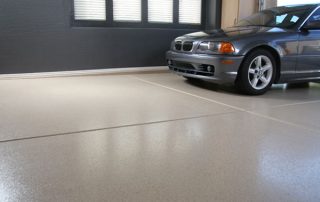 This image shows a garage floor with flake epoxy painted floor.