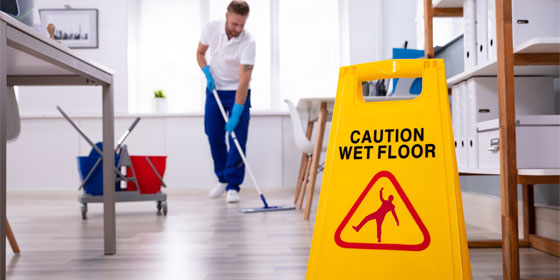 This image shows a man mopping the floor.