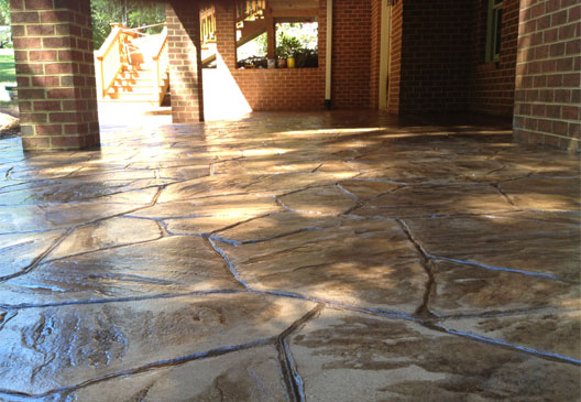This image shows a patio with stamped concrete overlay floor.
