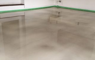 This image shows a garage floor with metallic epoxy painted floor.