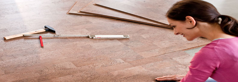 This image shows a woman putting Cork Flooring