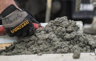 This image shows a man resurfacing a cement floor.