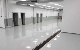 This image shows a commercial space with white epoxy floor.